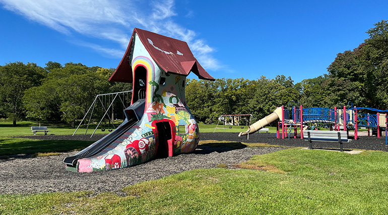 A playground with a slide shaped like a shoe